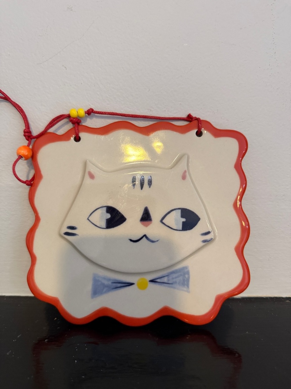 The Land of Nod Ceramic Cat Wall Plaque - White and Red Trim